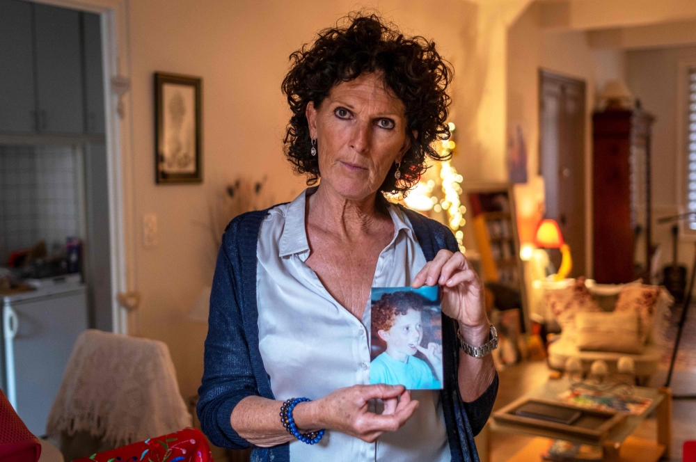 Christine Morin poses at her home in Narbonne on June 5, 2019, with a photograph of her son Thomas who joined Islamic State (ISIS) in 2015 at the age of 30 and was killed in the coalition bombing of Barghouz early in 2019. Christine Morin is calling for t