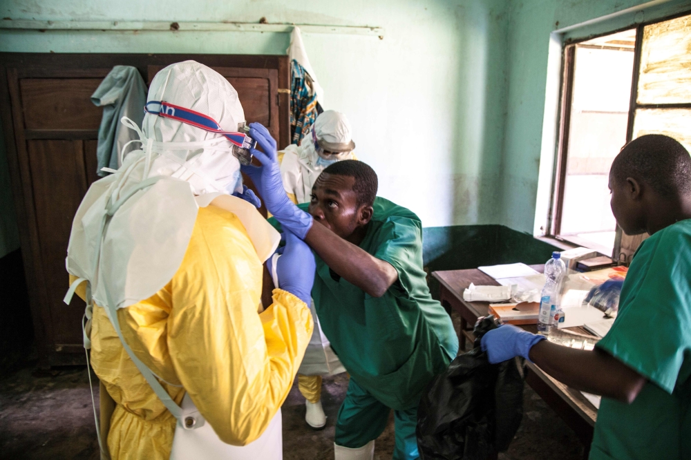 Health workers wear protective equipment as they prepare to attend to suspected Ebola patients at Bikoro Hospital in the Democratic Republic of Congo on May 12, 2018. AFP/UNICEF/Mark Naftalin