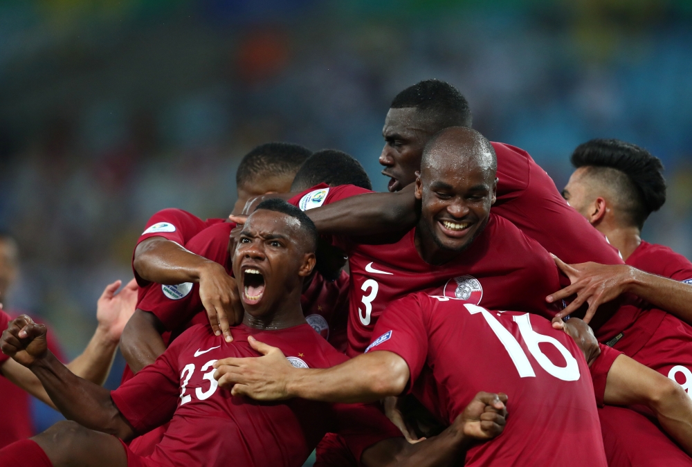 Qatar's Boualem Khoukhi celebrates scoring their second goal with team mates. Reuters/Pilar Olivares
