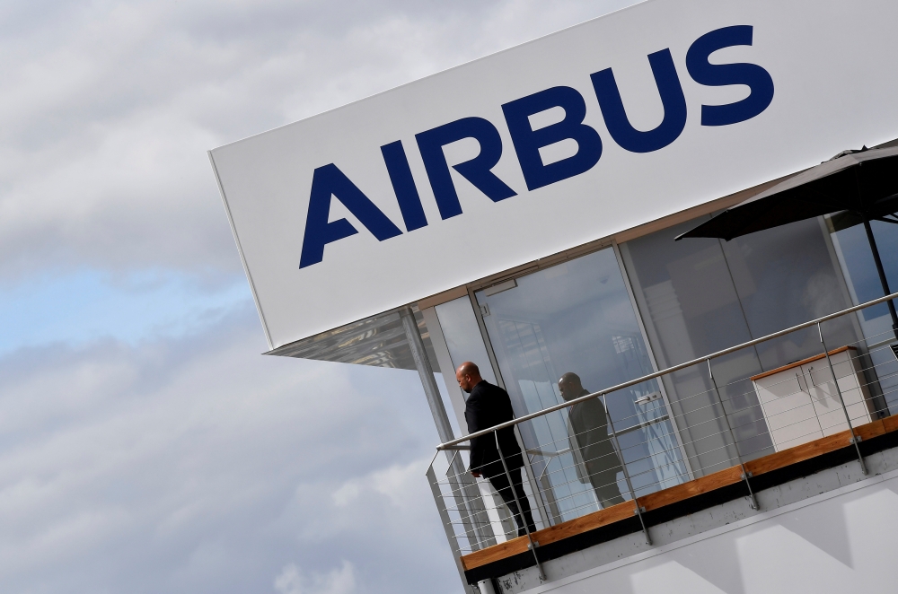 FILE PHOTO: A man stands at an Airbus trade pavilion at Farnborough International Airshow in Farnborough, Britain, July 17, 2018. REUTERS/Toby Melville/File Photo