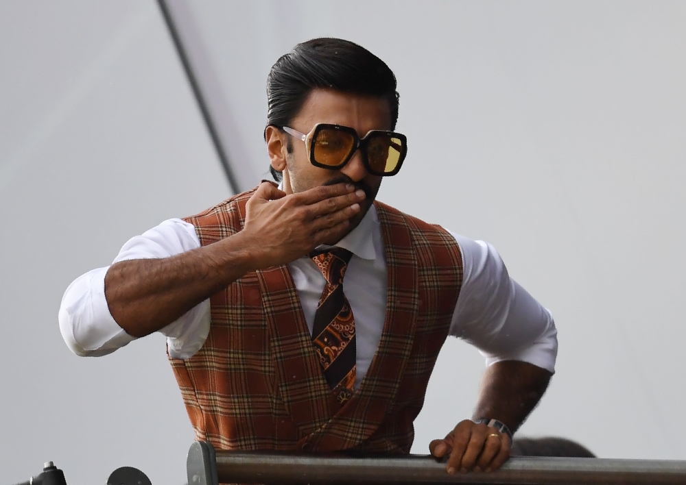 Indian Bollywood actor Ranveer Singh poses as he watches play during the 2019 Cricket World Cup group stage match between India and Pakistan at Old Trafford in Manchester, northwest England, on June 16, 2019. AFP / Dibyangshu Sarkar 