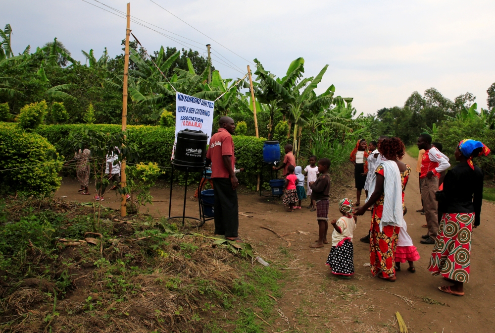 Guests attending a wedding ceremony wash their hands before entering the venue to avoid spreading of ebola virus in Kirembo village, near the border with the Democratic Republic of Congo, in Kasese district, Uganda June 15, 2019. Reuters/James Akena