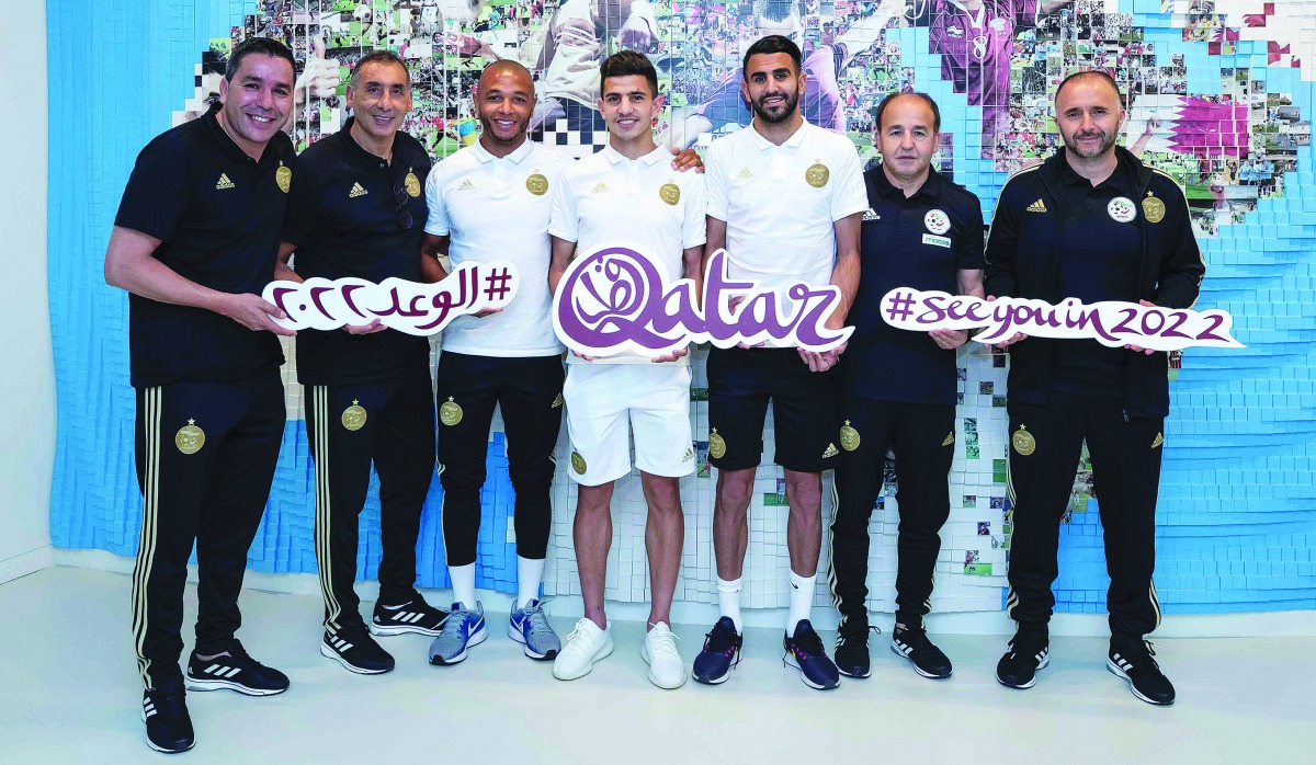 Manchester City player Riyad Mahrez (third right) and Algeria coach Djamel Belmadi (right) pose for a picture with other Algerian national team players and officials during their visit to the  Supreme Committee for Delivery & Legacy  Pavilion. 