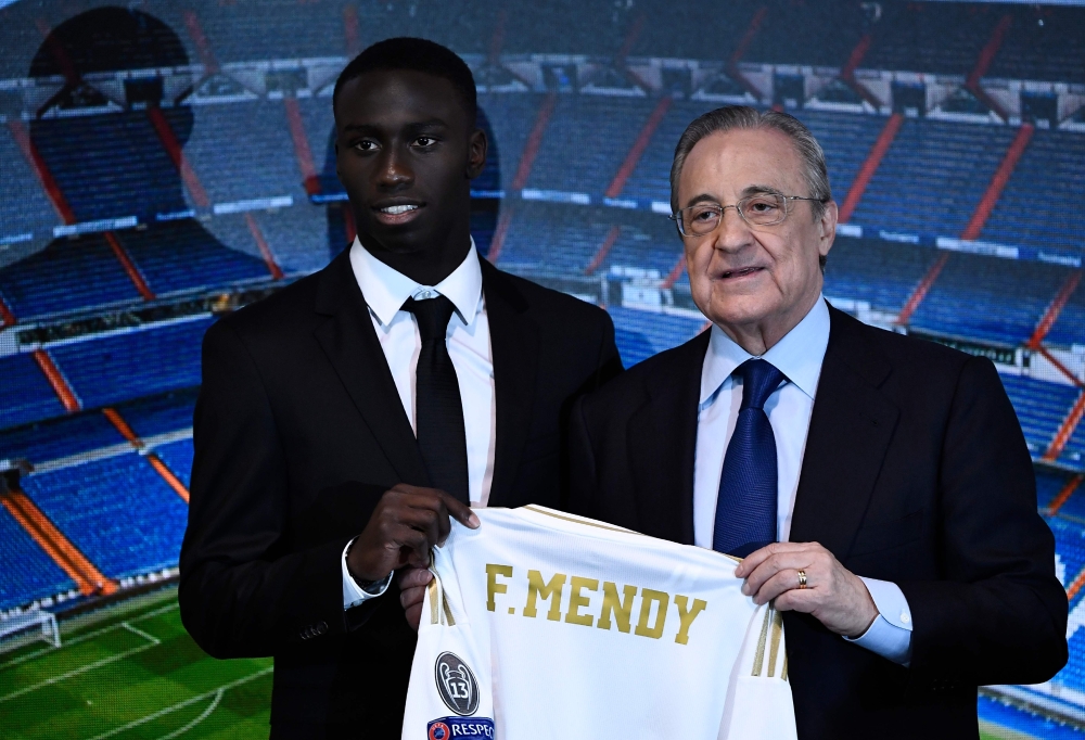 French defender Ferland Mendy (L) and Real Madrid's president Florentino Perez pose during the official presentation of the footballer as new player of the Spanish club at the Santiago Bernabeu stadium in Madrid on June 19, 2019. / AFP / OSCAR DEL POZO