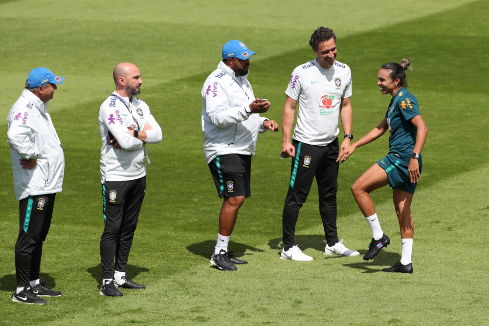 Brazil's Marta with the coaching staff during training REUTERS/Yves Herman