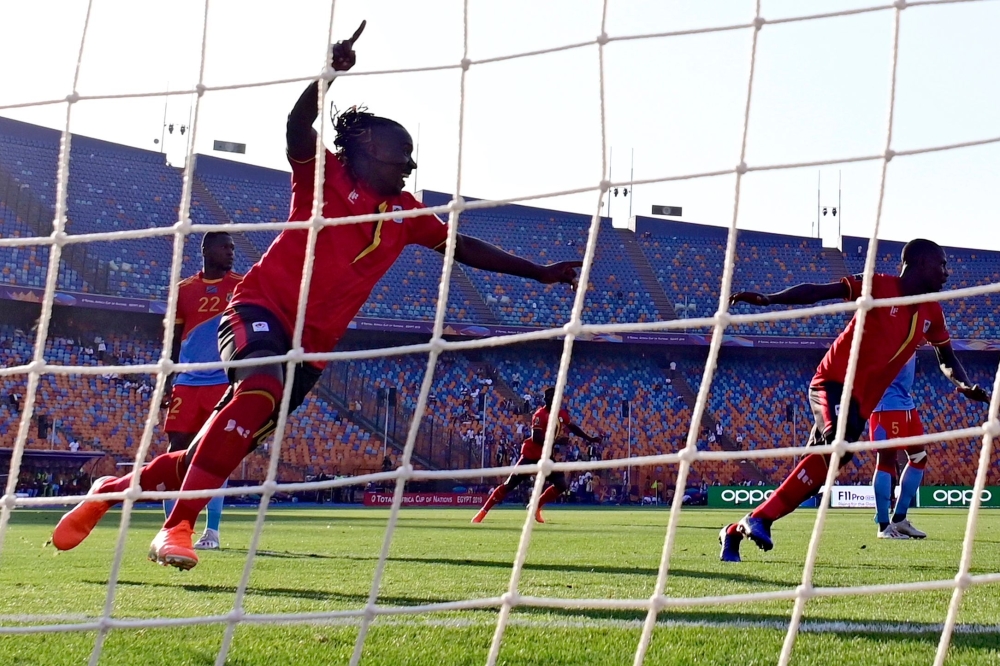 Uganda's defender Hassan Wasswa (L) celebrates a goal of his team during the 2019 Africa Cup of Nations (CAN) football match between DR Congo and Uganda at Cairo International Stadium on June 22, 2019. / AFP / JAVIER SORIANO