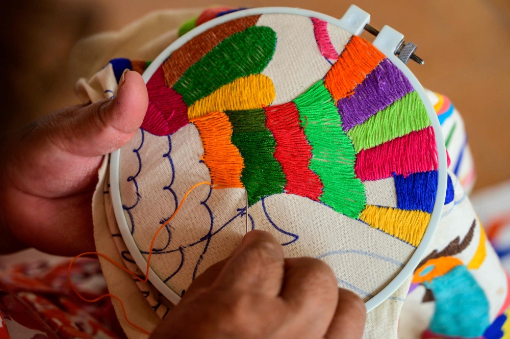 Mexican artisan Glafira Candelaria Jose, of the Otomi ethnic group, embroiders one of her designs at her workshop in San Nicolas village, in Tenango de Doria, Hidalgo state, Mexico, on June 18, 2019. AFP / Pedro PARDO
