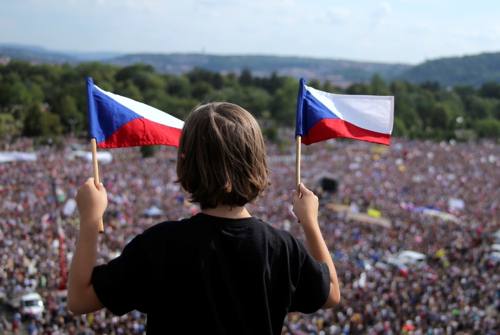 A demonstrator waves flags of the Czech Republic as he attends a protest rally demanding the resignation of Czech Prime Minister Andrej Babis in Prague, Czech Republic, June 23, 2019. Reuters/Milan Kammermayer
