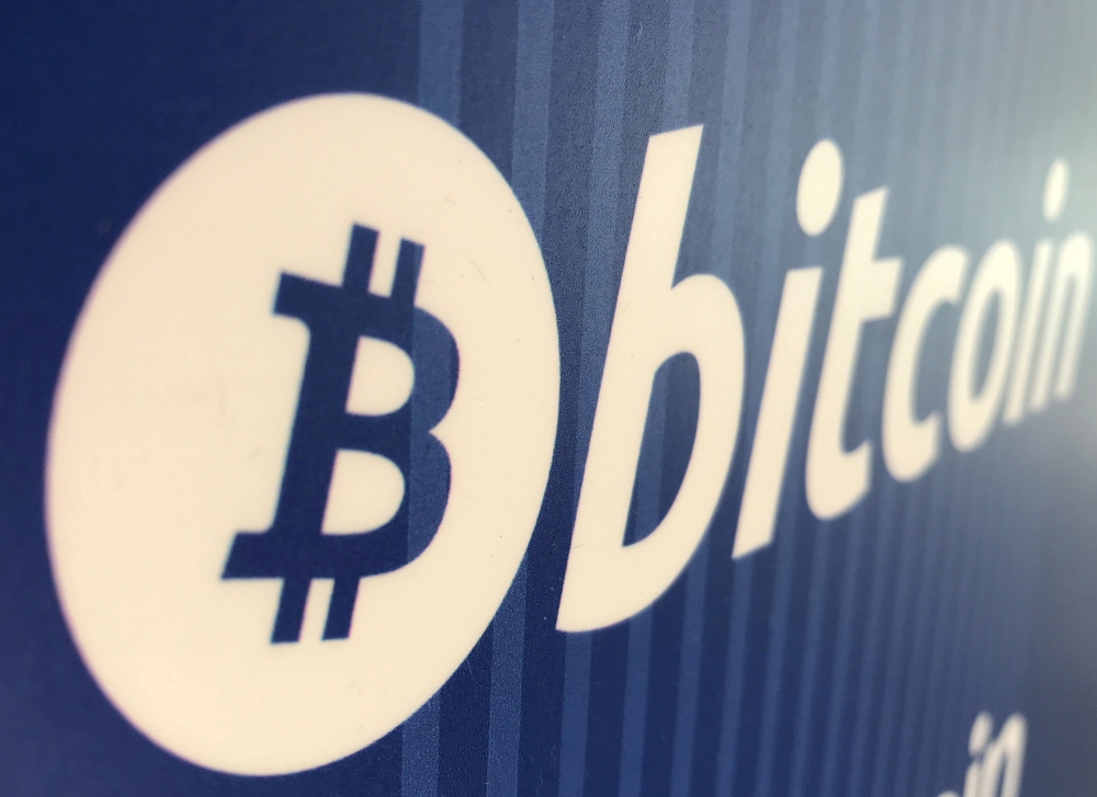 FILE PHOTO: A Bitcoin logo is seen on a cryptocurrency ATM in Santa Monica, California, U.S., January 4, 2018. REUTERS/Lucy Nicholson