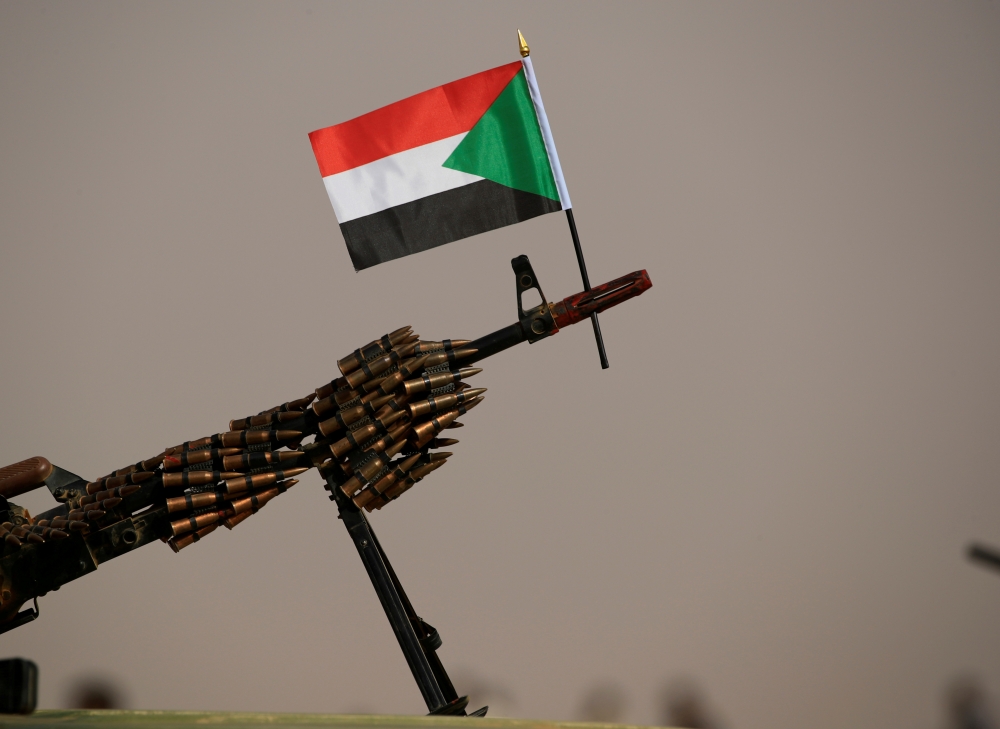 A Sudanese national flag is attached to a machine gun of Paramilitary Rapid Support Forces (RSF) soldiers as they wait for the arrival of Lieutenant General Mohamed Hamdan Dagalo, deputy head of the military council and head of RSF, before a meeting in Ap