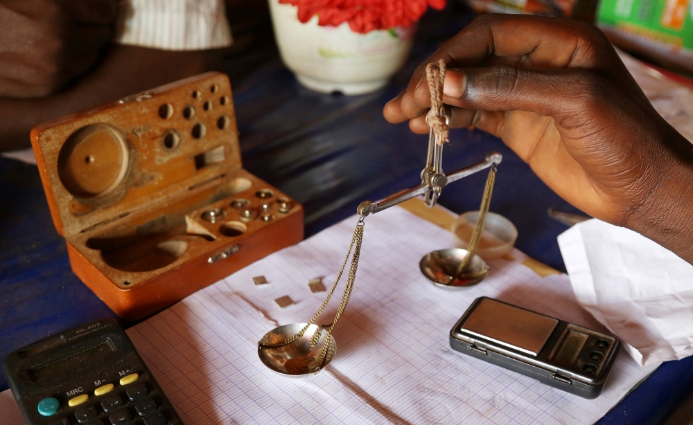 FILE PHOTO:A trader weighs gold in his shop in Djoubissi, Central African Republic on April 24, 2014. Reuters/Emmanuel Braun