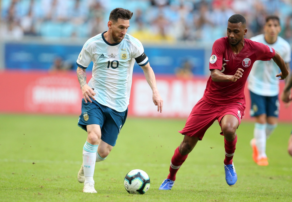 File photo of the players of Argentina (L) and Qatar during their Copa America Group B match in Porto Alegre, Brazil, on Sunday. 