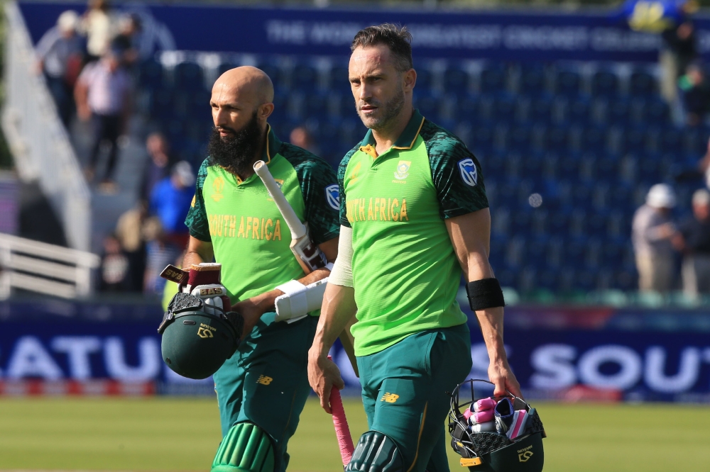 South Africa's captain Faf du Plessis (R) and South Africa's Hashim Amla leave the field at close of play during the 2019 Cricket World Cup group stage match between Sri Lanka and South Africa at the Riverside Ground, in Chester-le-Street, northeast Engla