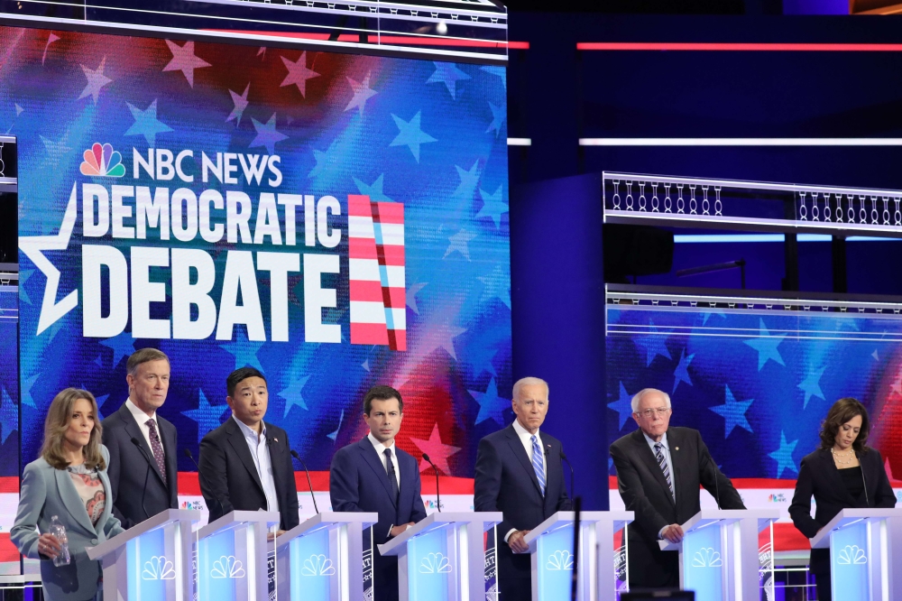 Democratic presidential candidates (L-R) Marianne Williamson, former Colorado governor John Hickenlooper, former tech executive Andrew Yang, South Bend, Indiana Mayor Pete Buttigieg, former Vice President Joe Biden, Sen. Bernie Sanders (I-VT), and Sen. Ka