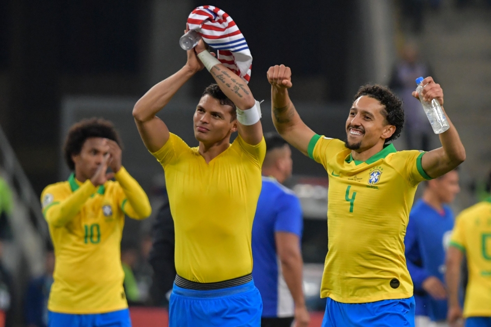 Brazil's Willian (L), Thiago Silva (C) and Marquinhos acknowledge the crowd after defeating Paraguay in a penalty shoot-out during their Copa America football tournament quarter-final match at the Gremio Arena in Porto Alegre, Brazil, on June 27, 2019. (A