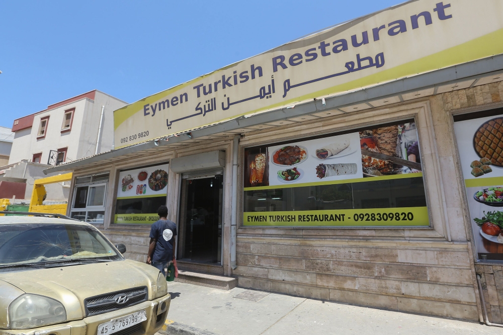 A Libyan man walks past a Turkish restaurant in Tripoli on June 30 , 2019. (AFP / Mahmud TURKIA)