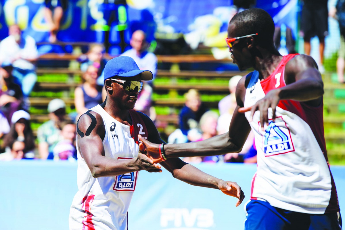 Qatar’s Ahmed Tijan (left) and Cherif Samba celebrate after scoring a point during their third and final Pool D match yesterday.
