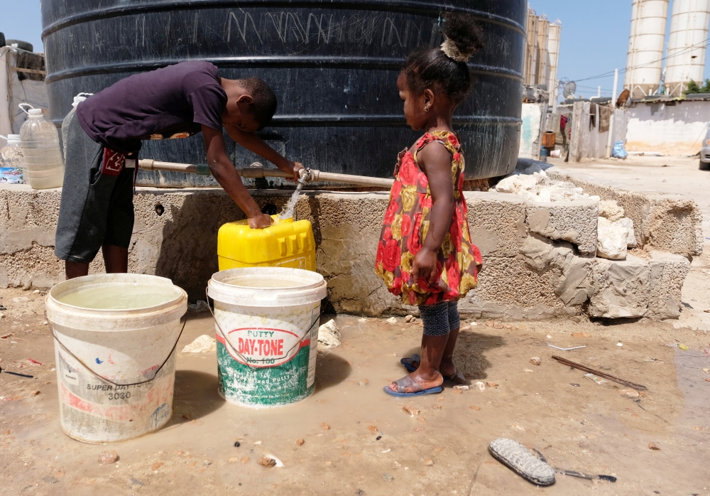 Libyan children displaced from the town of Tawergha fill containers with water at a displaced camp in Benghazi, Libya, June 19, 2019. Picture taken June 19, 2019. REUTERS/Esam Omran Al-Fetori