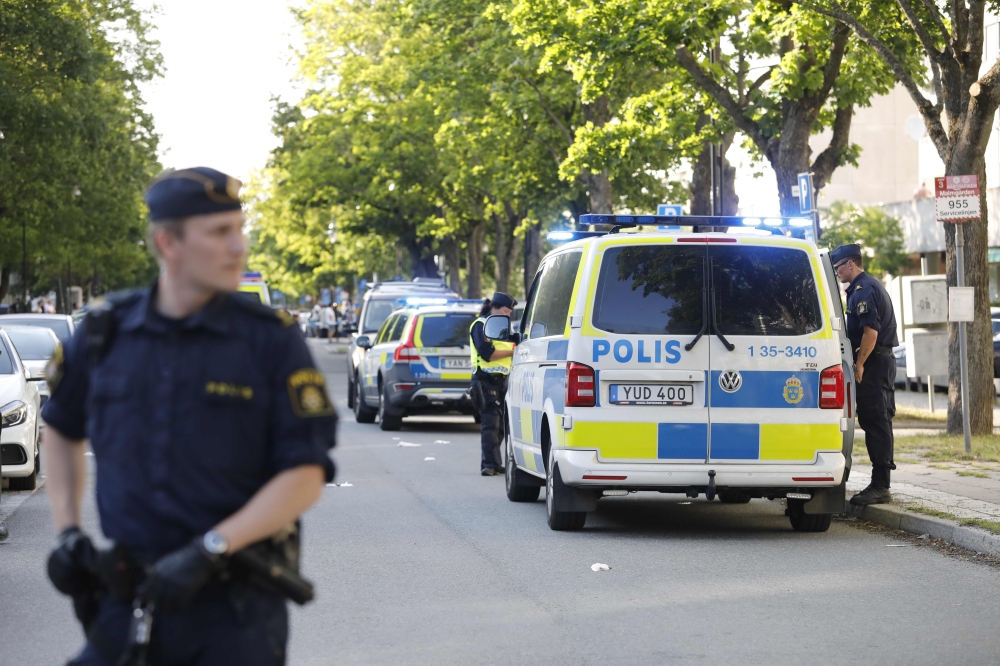 Picture dated June 30, 2019 shows police at the scene where two young men were shot in Sollentuna, north of Stockholm, Sweden. Sweden OUT / AFP / TT NEWS AGENCY / TT News Agency / Christine Olsson