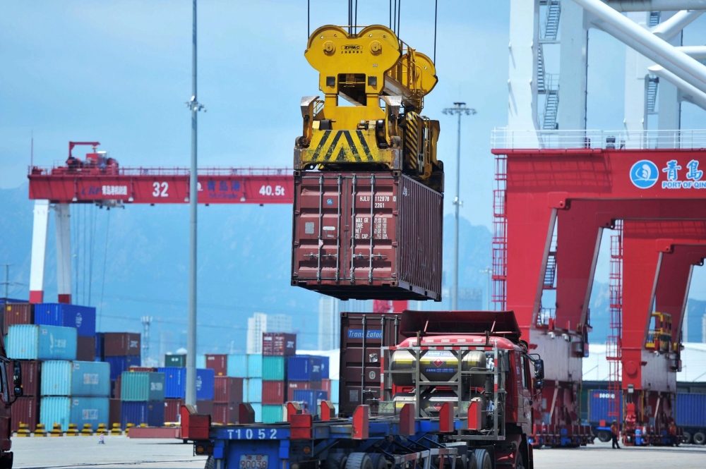 A container is transferred at a port in Qingdao, Shandong province in eastern China on July 6, 2018. (AFP) 