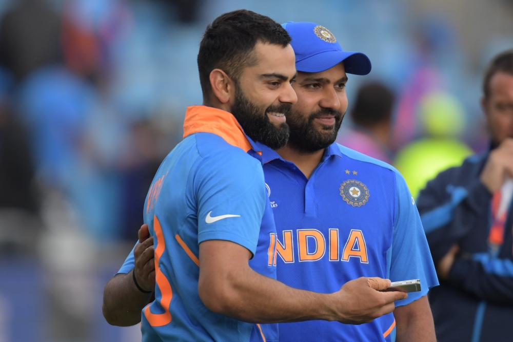 India's Rohit Sharma (R) is interviewed by India's captain Virat Kohli (L) on the pitch after India's victory in the 2019 Cricket World Cup group stage match between Sri Lanka and India at Headingley in Leeds, northern England, on July 6, 2019. (AFP / Dib