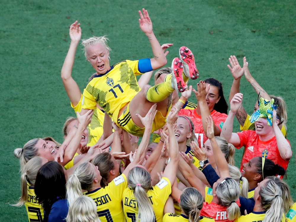 Sweden's Caroline Seger celebrates after the match with team mates REUTERS/Jean-Paul Pelissier
