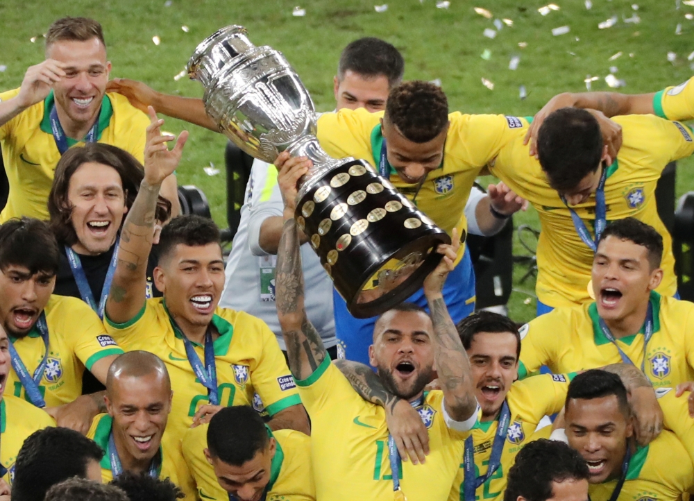 Brazil players celebrate winning the Copa America with the trophy. Reuters/Sergio Moraes