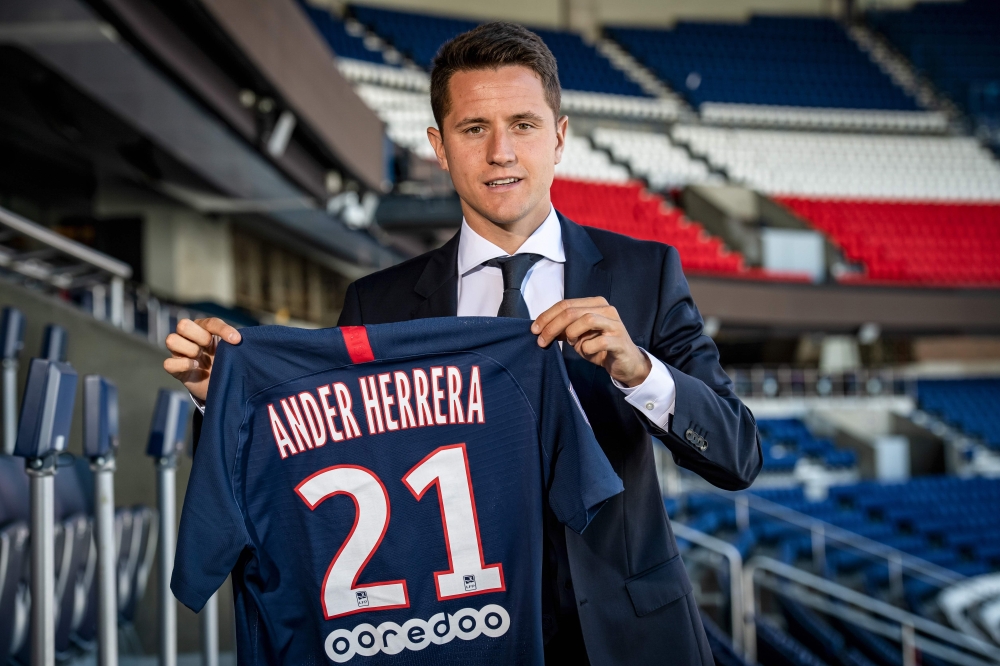 Spanish midfielder Ander Herrera poses with the PSG jersey after he signed a five-year contract with the Paris Saint-Germain football club at the Parc des Princes, in Paris on July 4, 2019. AFP / BERTRAND GUAY