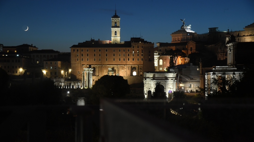 The Campidoglio (Rear C) and the Roman Forum are pictured as the moon rises over Rome within the outdoors presentation of Italian fashion house Fendi's Couture Fall/Winter 2019-2020 show on July 4, 2019, at the Palatine Hill in Rome, with the Colosseo (Co