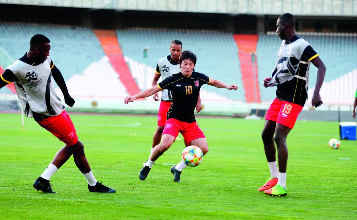 Al Duhail’s Japanese international player Shoya Nakajima passes the ball to team-mate Almoez Ali (right) during a training session held in Tehran, Iran, in this file picture.