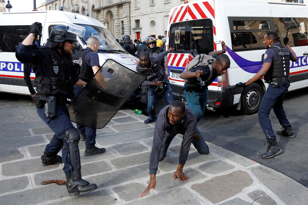 Riot police officers clash with undocumented migrants outside the Pantheon in Paris, France, July 12, 2019. Reuters/Charles Platiau