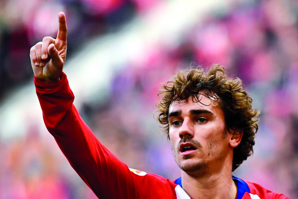 In this file photo taken on February 09, 2019 Atletico Madrid's French forward Antoine Griezmann celebrates after scoring during the Spanish league football match Club Atletico de Madrid against Real Madrid CF at the Wanda Metropolitano stadium in Madrid.