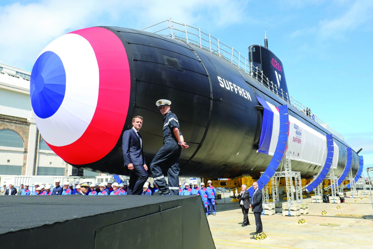 French President Emmanuel Macron (L) attends the official launch ceremony of the new French nuclear submarine 