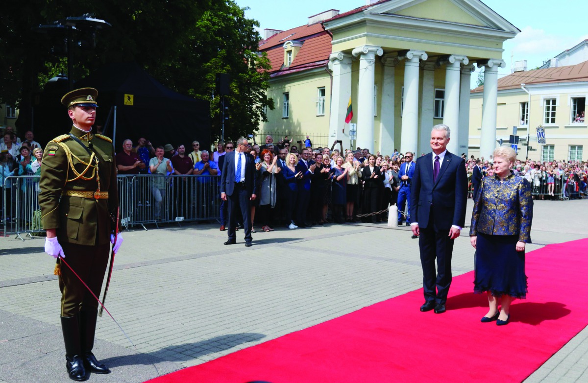 Lithuania's president, Gitanas Nauseda and his predecessor Dalia Grybauskaite stand on the red carpet during the handover ceremony at the presidential palace on July 12, 2019 in Vilnius. / AFP / Petras Malukas
