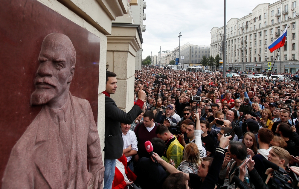 Russian opposition figure Ilya Yashin addresses his supporters, next to a bas-relief of Soviet state founder Vladimir Lenin, at a rally to protest against alleged violations ahead of elections to Moscow City Duma, the capital's regional parliament, in Mos