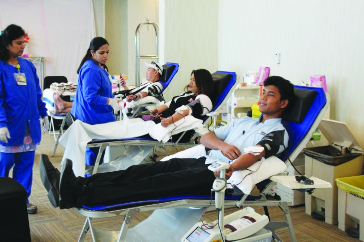 Employees and guests donating blood.
