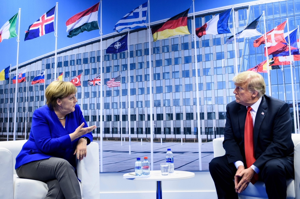 FILE PHOTO: Angela Merkel and Donald Trump make a statement to the press after a bilateral meeting on the sidelines of the NATO summit in Brussels on July 11, 2018. AFP/Brendan Smialowski