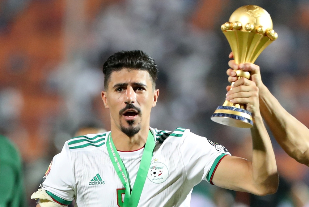 Algeria's Baghdad Bounedjah celebrates with the trophy after winning the Africa Cup of Nations (REUTERS/Suhaib Salem)