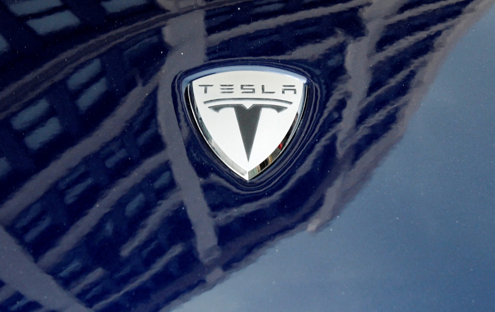 A logo of Tesla Motors on an electric car model is seen outside a showroom in New York, June 28, 2010. Reuters/Shannon Stapleton