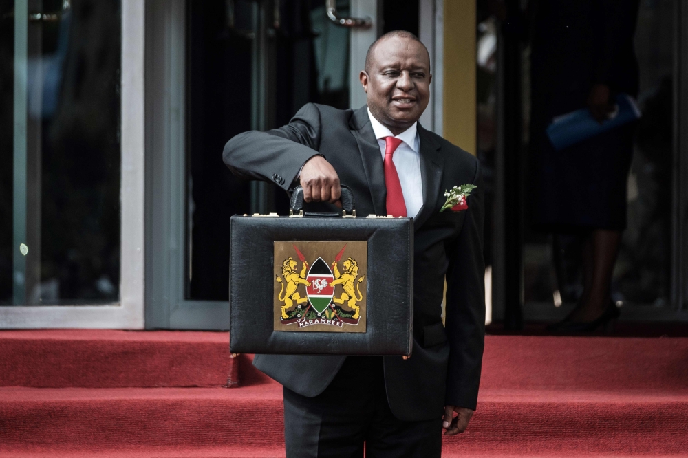 In this file photo taken on June 14, 2018 Kenya's Cabinet Secretary for National Treasury Henry Rotich poses with the budget briefcase before leaving for Parliament to read the budget speech for 2018-2019 in Nairobi, Kenya.