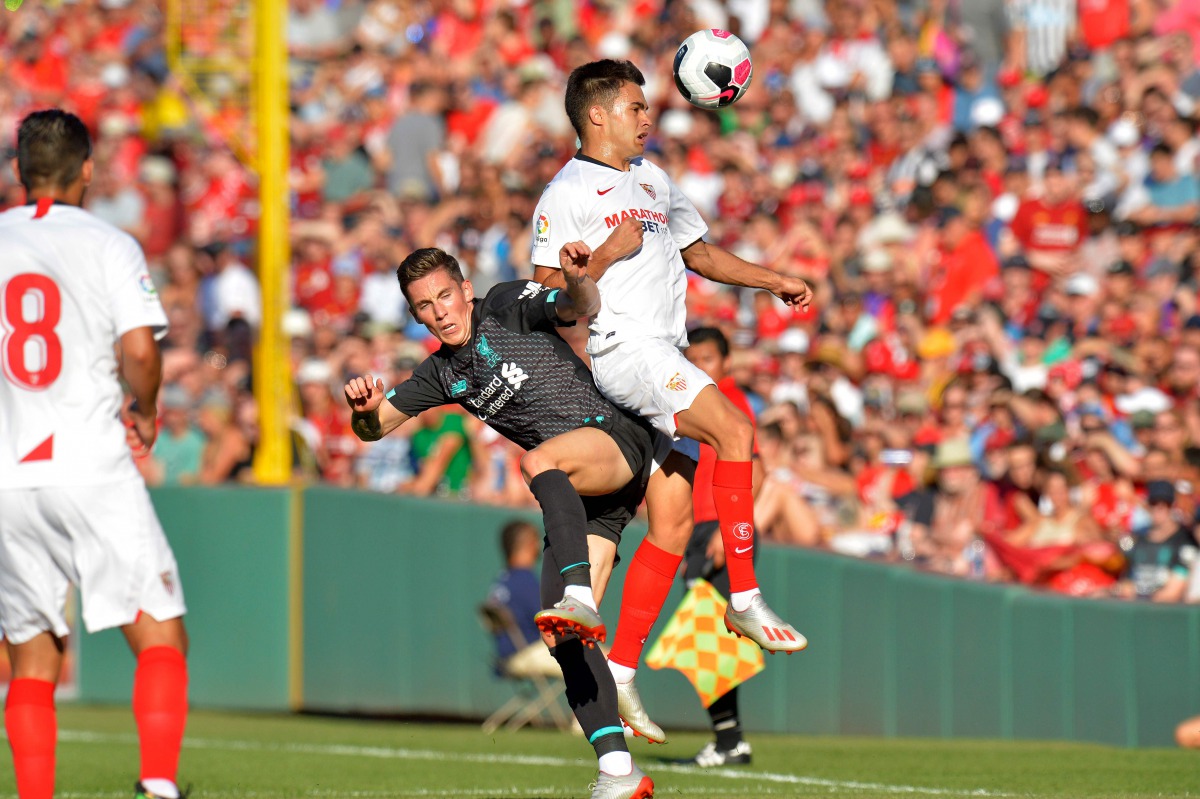 Liverpool's Harry Wilson (L) and Sevilla's Rodriguez Sergio Reguilon fight for the ball during a pre-season friendly match between Liverpool FC and Sevilla FC at Fenway Park in Boston on July 21, 2019. / AFP / Joseph Prezioso

