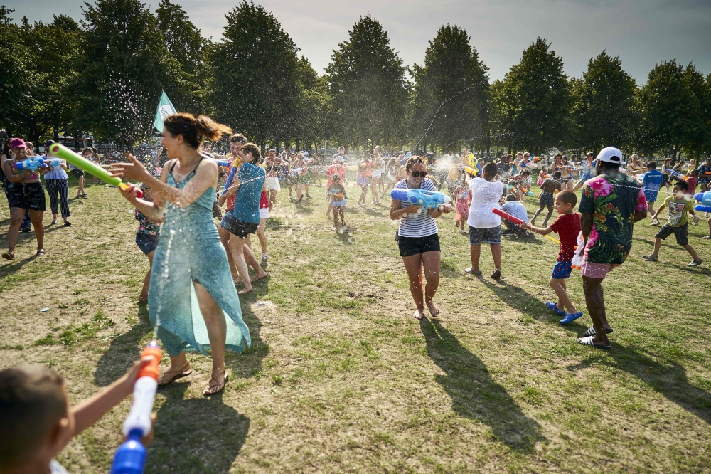 People cool off as they enjoy a water fight on the Malieveld, in The Hague city center, on July 24, 2019, during a heatwave. Belgium and the Netherlands recorded their highest ever temperatures as a European heatwave neared its peak on July 24. (AFP / ANP