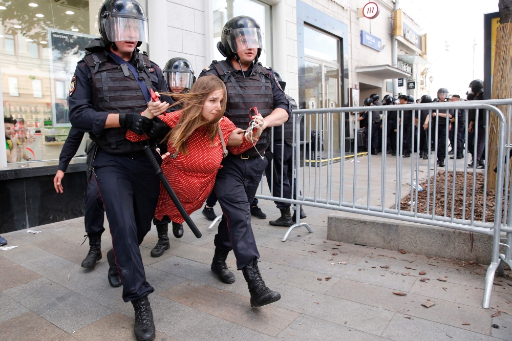 Police officers detain a protester during an unauthorised rally demanding independent and opposition candidates be allowed to run for office in local election in September, in downtown Moscow on July 27, 2019. (AFP / Maxim ZMEYEV)