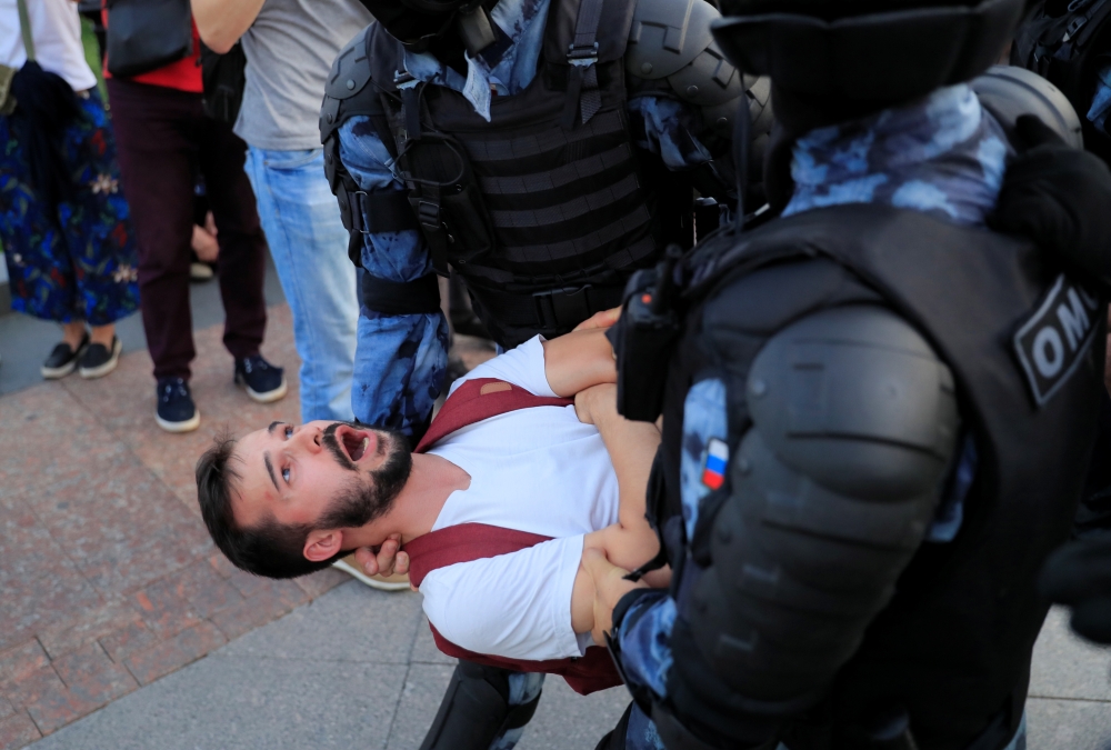Law enforcement officers detain a participant of a rally calling for opposition candidates to be registered for elections to Moscow City Duma, the capital's regional parliament, in Moscow, Russia July 27, 2019. REUTERS/Tatyana Makeyeva