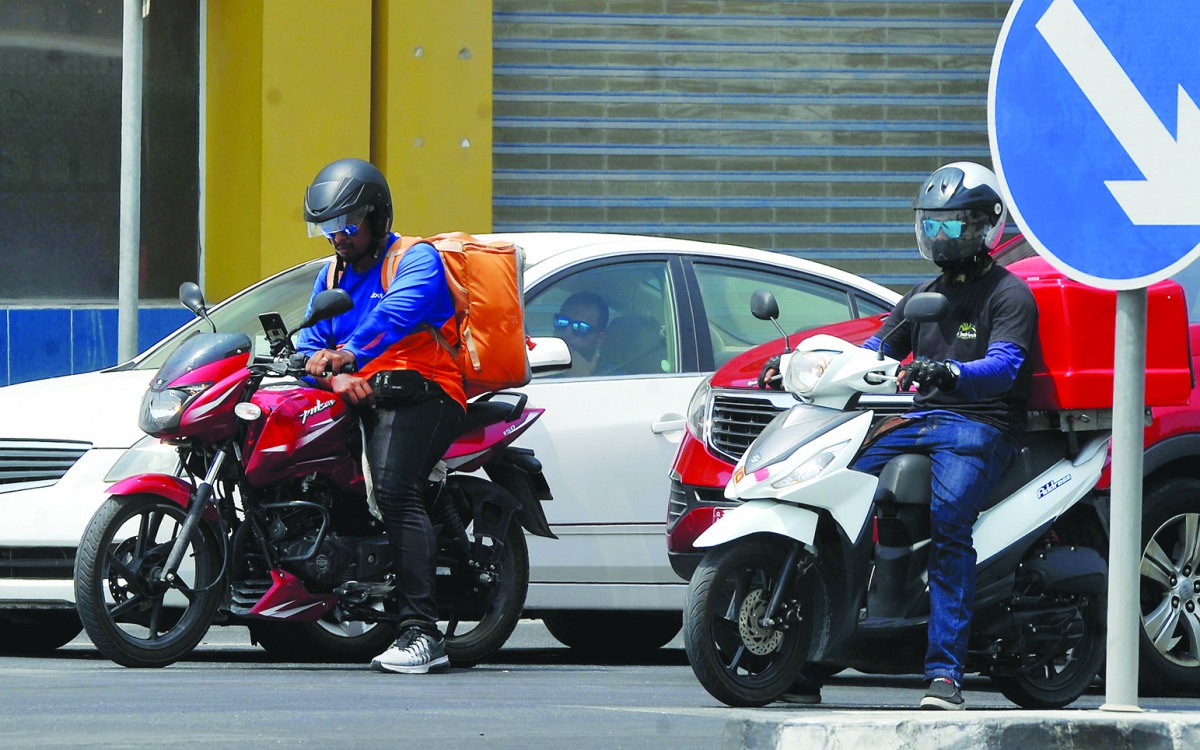 Delivery boys navigating traffic on a busy road in Doha. Pic:Abdul Basit/ The Peninsula