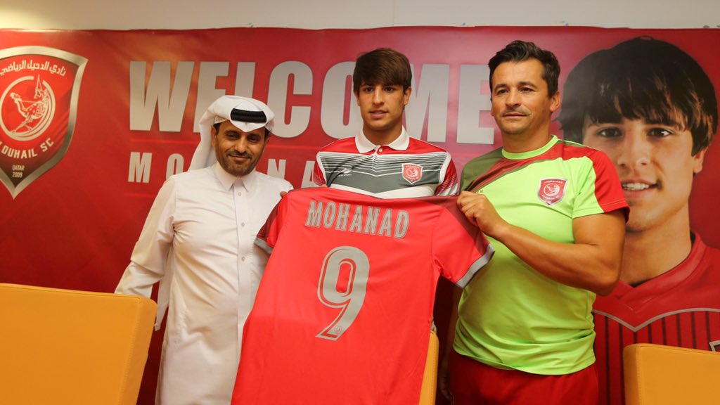 Iraqi star Mohanad Ali (centre) holding an Al Duhail jersey with coach Rui Faria and a club official during a press conference in Doha, yesterday.
