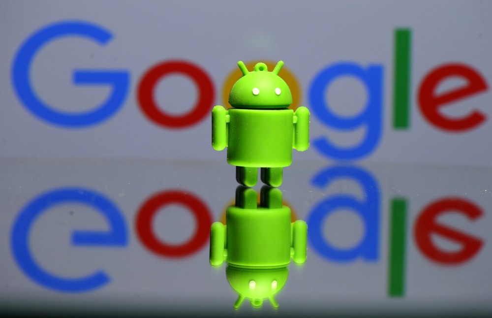 A 3D printed Android mascot, Bugdroid, seen in front of a Google logo in this illustration taken July 9, 2017. (REUTERS/Dado Ruvic/Illustration/File Photo)