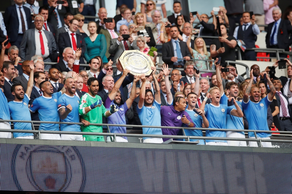 Manchester City's Sergio Aguero and David Silva celebrate winning the FA Community Shield with team mates REUTERS/David Klein