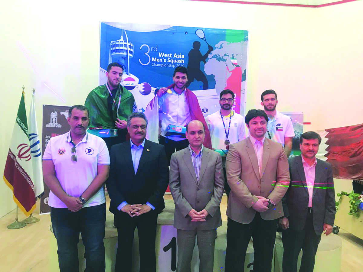 Men’s singles gold medallist, Qatar’s Abdullah Al Tamimi (top, centre) and his team-mate, joint-bronze winner Syed Azlan Amjad, celebrate on the podium with officials during the West Asian Squash Championship in Tehran, Iran, yesterday.
