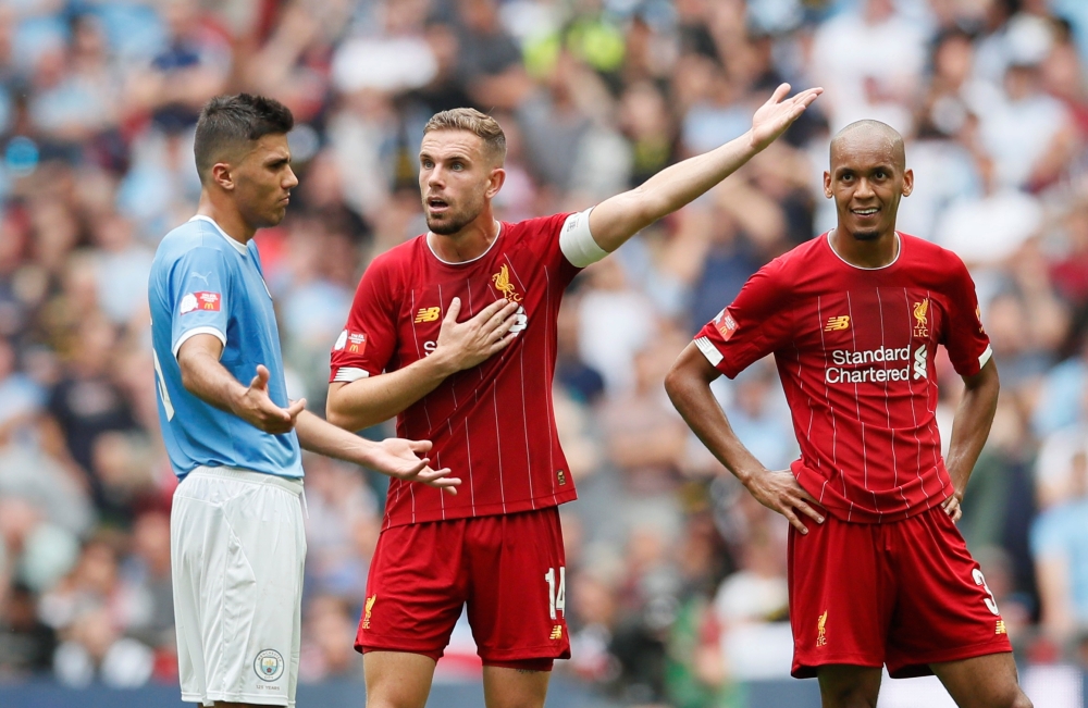 Manchester City's Rodri reacts as Liverpool's Jordan Henderson and Fabinho react REUTERS/David Klein